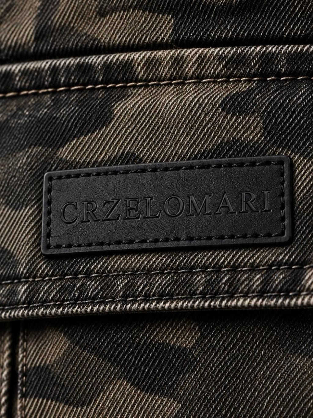 Close-up of the CRZELOMARI logo patch on the cargo pocket flap of the camo shorts