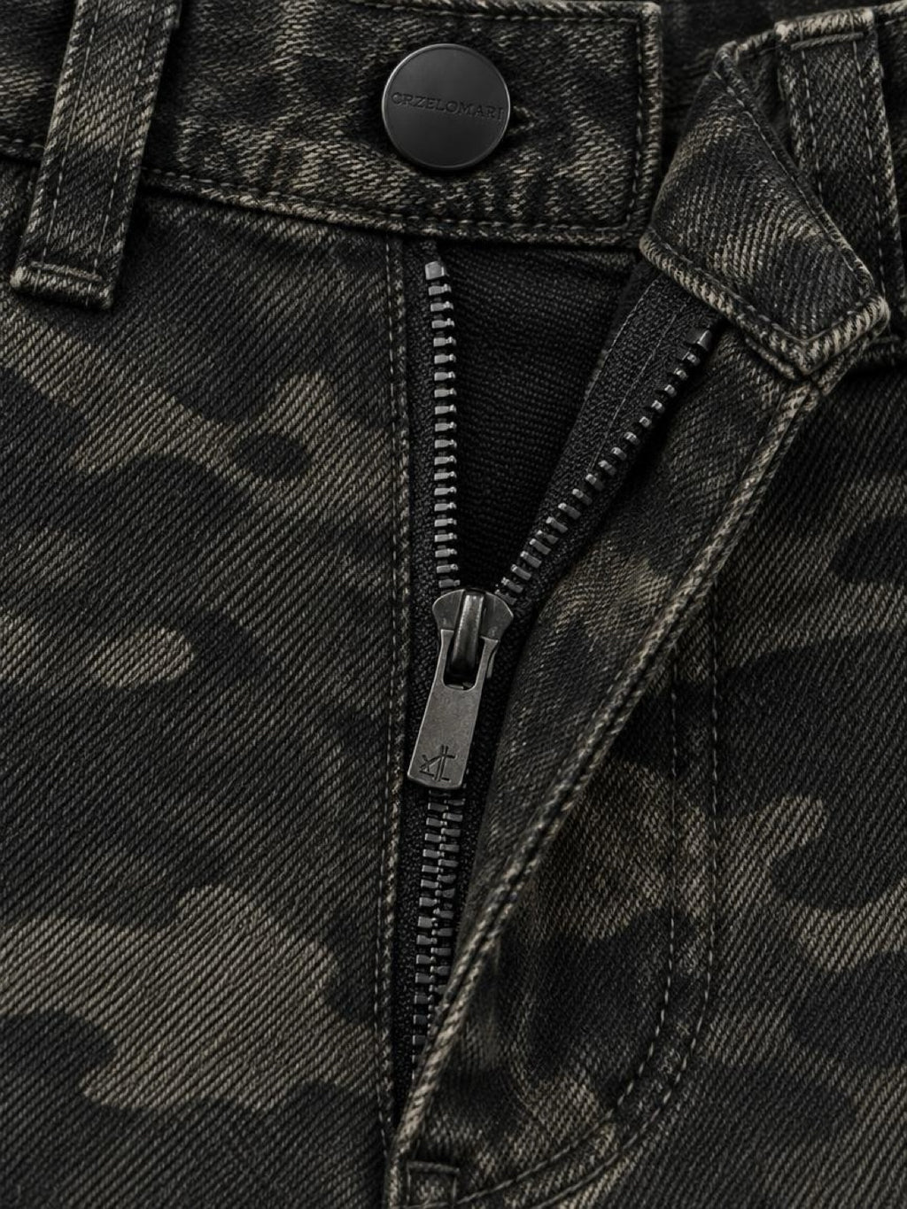 Close-up of the zip fly and matte black hardware on camo cotton denim cargo shorts