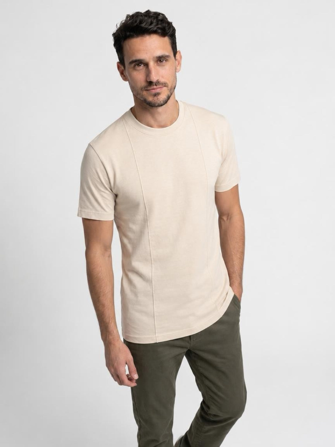 Tall man walking in The Founders Tee in cream, a men's tall T-shirt paired with olive pants