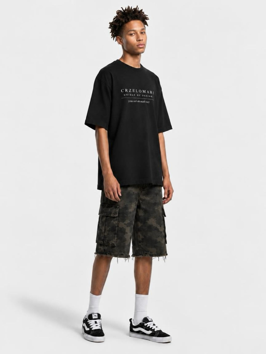 Tall man wearing CRZELOMARI Field Camo Cargo Shorts with a 14" inseam and a black tee, full-length view