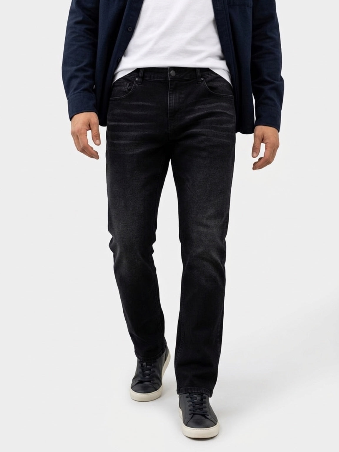 Tall man wearing CRZELOMARI Form Denim black tall jeans with a slim-straight athletic fit