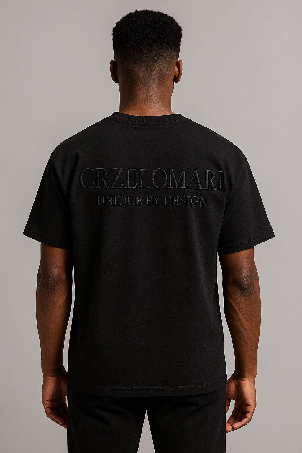 Back view of luxury black long-length t-shirt for tall men with embossed Crzelomari branding